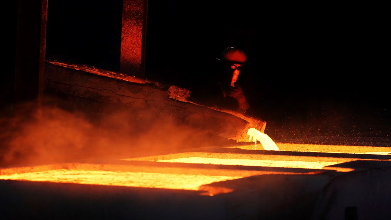 Worker pouring liquid molten metal