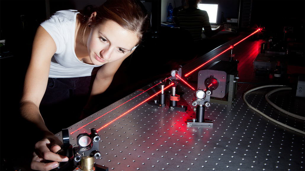 female scientist doing research in dark room